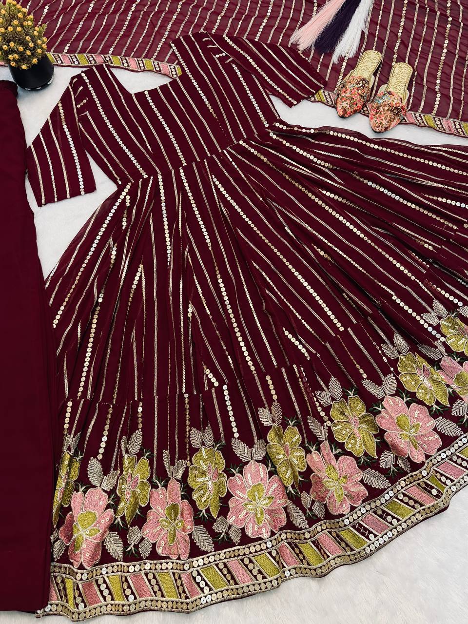 Majestic Maroon Flared Anarkali Suit Set Adorned with Luminous Sequin Stripes and an Ornate Floral Embroidered Hemline